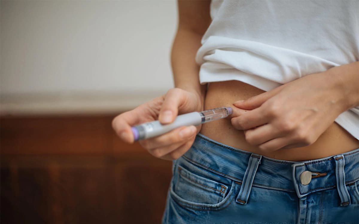 Patient self-administering a GLP-1 weight loss injection